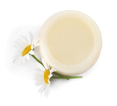 Solid shampoo bar and chamomiles on white background, top view. Hair care Stock Photos
