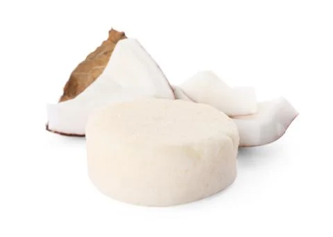 Solid shampoo bar and coconut pieces on white background. Hair care Foto stock