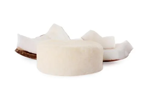 Solid shampoo bar and coconut pieces on white background. Hair care Foto stock