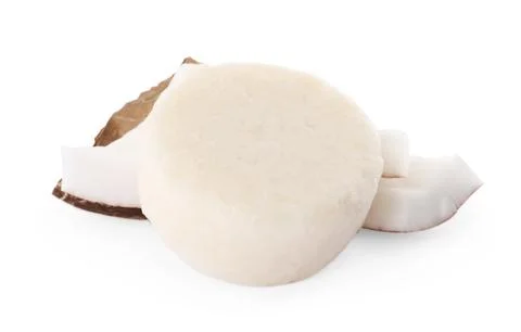 Solid shampoo bar and coconut pieces on white background. Hair care 写真素材