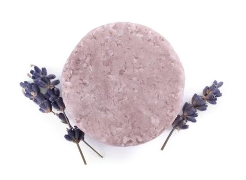 Solid shampoo bar and lavender flowers on white background, top view. Hair ca 写真素材
