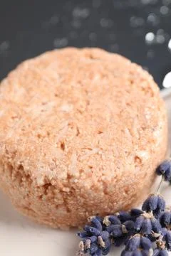 Solid shampoo bar and lavender flowers on white table, closeup Stock Photos