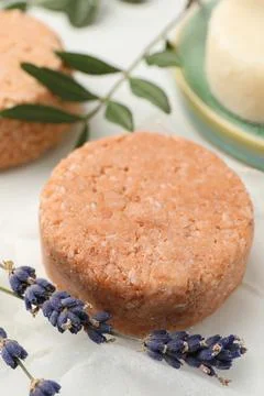 Solid shampoo bar and lavender on light table, closeup 写真素材