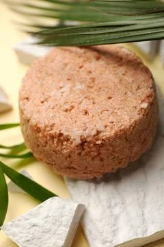 Solid shampoo bar and leaf on beige table, closeup. Hair care Stock Photos