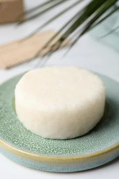 Solid shampoo bar and leaf on white table, closeup. Hair care 写真素材