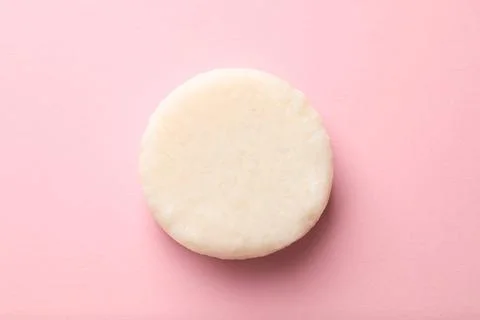 Solid shampoo bar on pink background, top view 写真素材