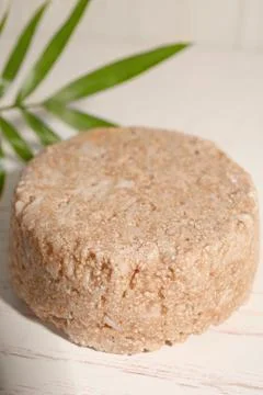 Solid shampoo bar on white wooden table, closeup Stock Photos