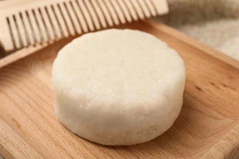 Solid shampoo bar on wooden tray, closeup 写真素材