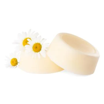 Solid shampoo bars and chamomiles on white background. Hair care 写真素材