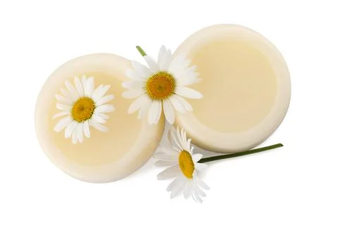Solid shampoo bars and chamomiles on white background, top view. Hair care Foto stock