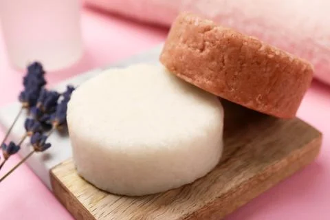 Solid shampoo bars and lavender on pink table, closeup. Hair care 写真素材