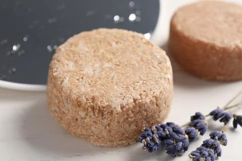 Solid shampoo bars and lavender flowers on white table, closeup 스톡 사진