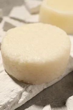 Solid shampoo bars on light grey table, closeup Stock Photos