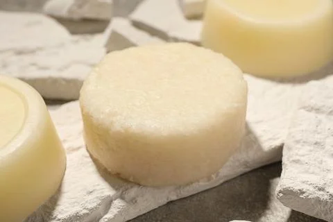 Solid shampoo bars on light grey table, closeup Stock Photos