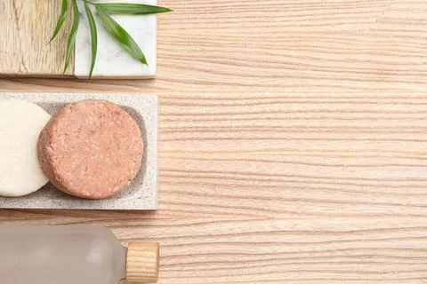 Solid shampoo bars on wooden table, flat lay. Space for text 스톡 사진