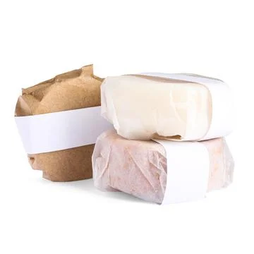 Solid shampoo bars wrapped in parchment on white background Stock Photos