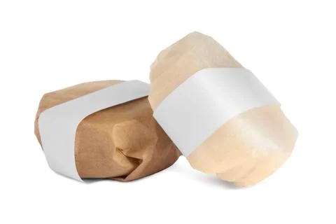 Solid shampoo bars wrapped in parchment on white background Stock Photos