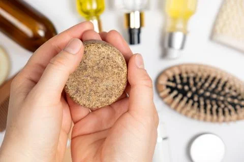 Solid shampoo in female hands. Natural eco-cosmetics without plastic for the Stock Photos