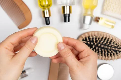 Solid shampoo in female hands. Natural eco-cosmetics without plastic for the Stock Photos