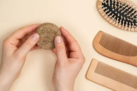 Solid shampoo in female hands. Natural eco-cosmetics without plastic for the  Stock Photos