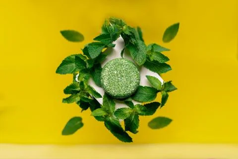 Solid shampoo with the smell of mint on a bright background yellow Stock Photos