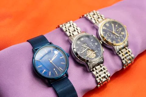 A solid silver watch on the table. The color flashed blue Stock Photos