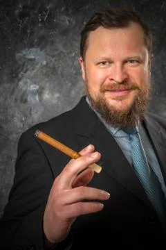 Solid smoling bearded man in suit with cigar Stock Photos