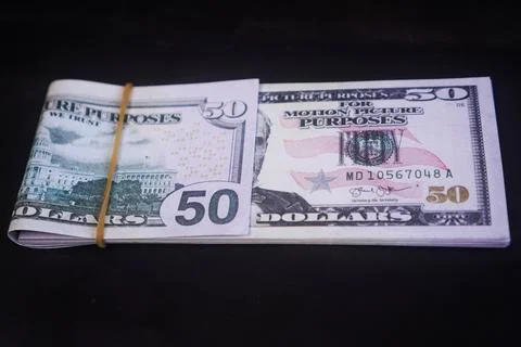 A solid stack of United States fifty dollar banknotes folded in half and se.. Stock Photos
