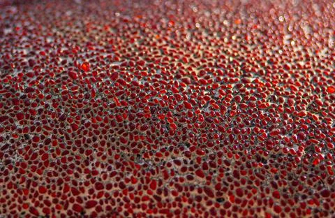 Solid texture of a uniform covering a street wall with a mosaic of rounded de Stock Photos