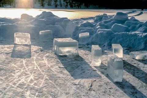Solid, transparent ice blocks standing on frozen water on a cold, frosty winter Stock Photos