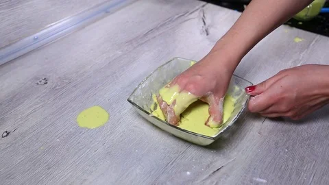 Solid turns into a liquid in the hands of a woman. drains into a glass dish Stock Footage 125481721