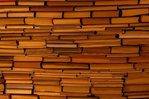 Solid Wall Background of Stacked Old Books and Paper Textures Stock Photos