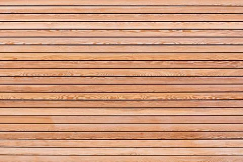 A solid wall of brown wooden planks arranged horizontally. Concept for textur Stock Photos