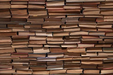 Solid Wall of Stacked Vintage Books Creating a Textured Paper Background Stock Photos
