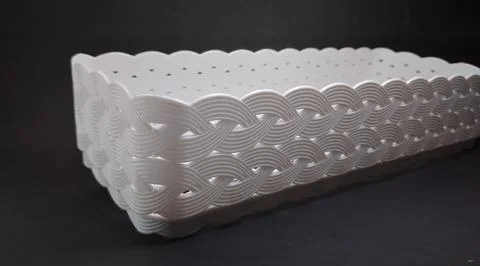 Solid white rectangular Plastic Storage Box, with woven texture, black back.. Foto stock
