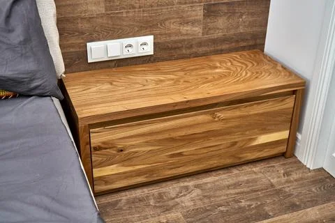 Solid wood nightstand in the interior. Solid elm nightstand. Details furniture Stock Photos