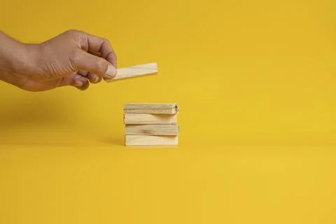 Solid wooden locks on a yellow background Foto stock