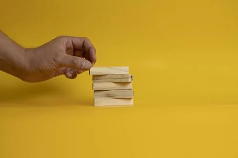 Solid wooden locks on a yellow background Stock Photos