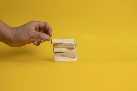 Solid wooden locks on a yellow background Stock Photos