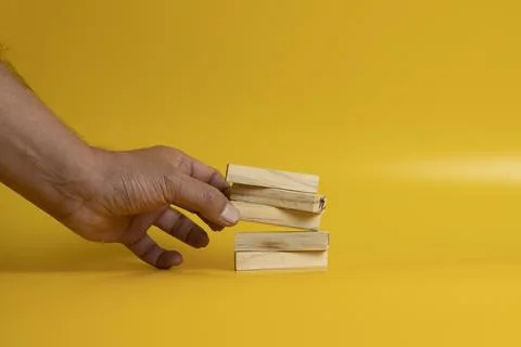 Solid wooden locks on a yellow background Stock Photos