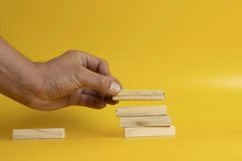 Solid wooden locks on a yellow background Stock Photos