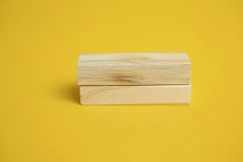Solid wooden locks on a yellow background Stock Photos