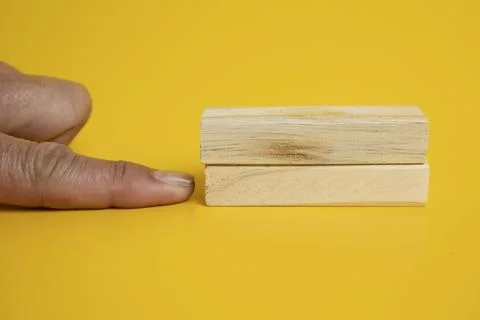 Solid wooden locks on a yellow background Foto stock