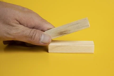 Solid wooden locks on a yellow background Foto stock