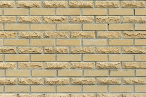 Solid yellow and beige brick wall. Brick background. Foto stock
