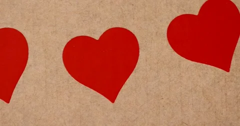 Solid yellow cardboard for packaging goods and products with red plastic hearts Stock Footage 325241650