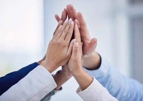 Solidarity, high five and support with hands of business people in office for Stock Photos