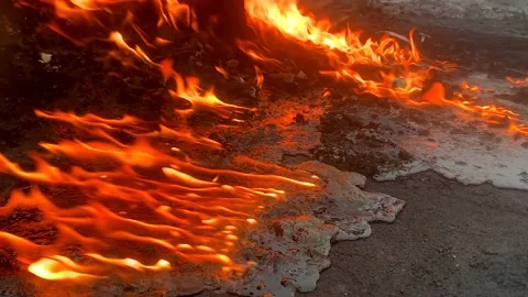 Solidified lava burns in fire. Pollution of ecology and environment Video stock 200493459