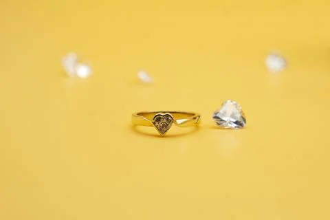 Solitaire engagement ring round cut yellow background Stock Photos