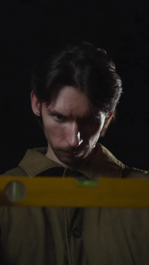 Solitary young man in dramatic low key lighting Stock Footage 346987630